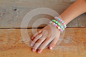 Child wears bracelets on his hand