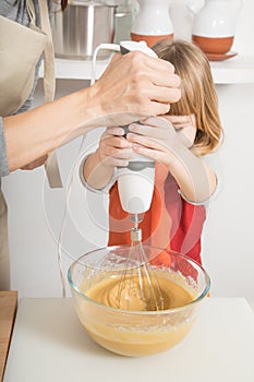 Child whipping with electric mixer