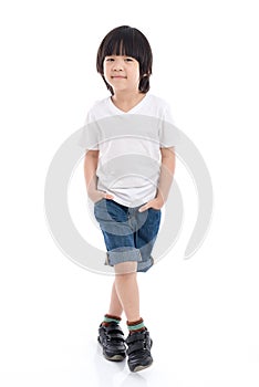 Child in white t-shirt and jeans standing on white background