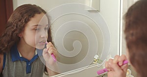 Child with white tooth looking at mirror isolated at home. Smiling Lifestyle. Portrait cute Caucasian Young teenage girl