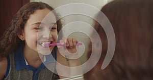 Child with white tooth looking at mirror isolated at home. Smiling Lifestyle. Portrait cute Caucasian Young teenage girl