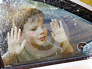 Child and window on a wet rainy day