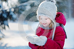 Child in the winter forest. Around the snow and branches of fir