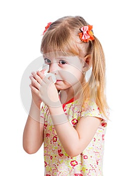 Child wiping or cleaning nose with tissue isolated on white