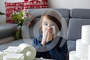 Child, wiping his nose with toilet paper at home, kid with running nose