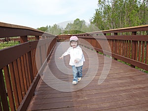 Child on wooden walkway
