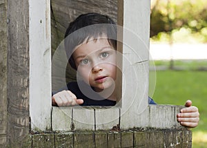 Child in wooden window