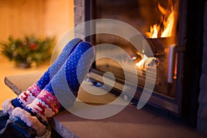 Child in woolen sock warming his feet