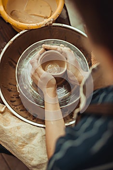 Child working hands with clay