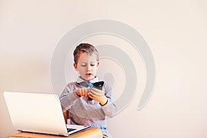 Child working with his computer in his business, concentrated typing to succeed, funny image