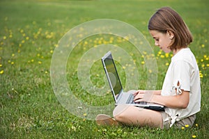 Child working laptop outside