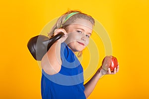 Child workout. Kid sport. Child exercising with kettlebell dumbbells. Sporty child with dumbbell.