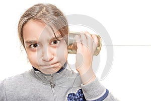 Child worried hears from the phone built with the tin