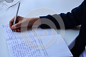 Child writes in notebooks at the window on quarantine photo