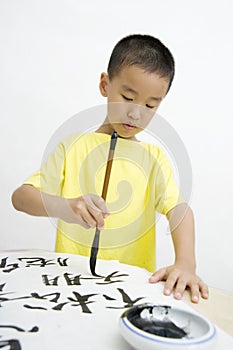 A child writing Chinese Calligraphy