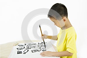 A child writing Chinese Calligraphy
