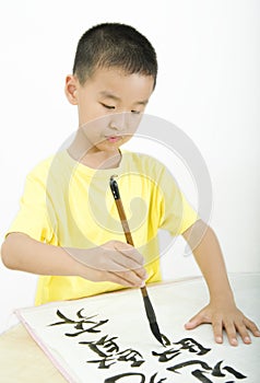 A child writing Chinese Calligraphy