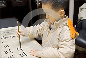 A child writing Chinese Calligraphy photo