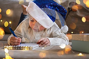 Child writing wish letter to Santa Claus