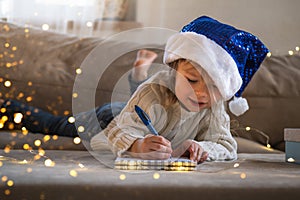 Child writing wish letter to Santa Claus