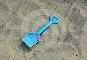 Childs spade / shovel on a sandy beach