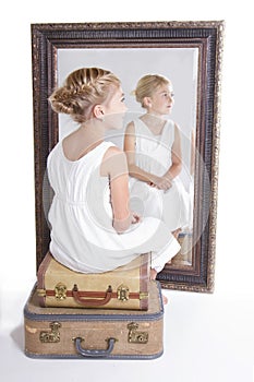 Child or young girl in front of a mirror