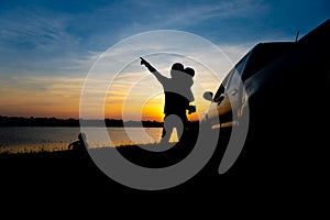 Childern are playing on the lake at sunset. People have fun on the field.