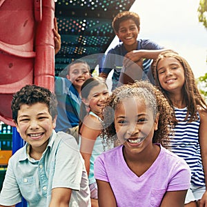 Childhood is all about having fun. a group of young friends hanging out together at a playground.