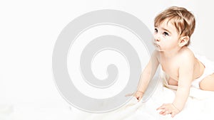 Childhood, babyhood and people concept - little baby boy or girl crawling on floor at home