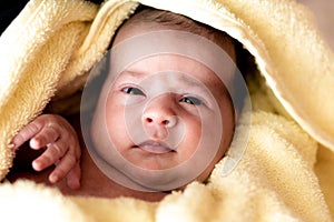 Childhood, care, hygiene, motherhood, innocence concepts - Close up Wet awake Infant newborn after taking shower wrapped