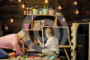 Childhood concept.Family play with constructor at home. Mom and child play with details of constructor, plastic bricks