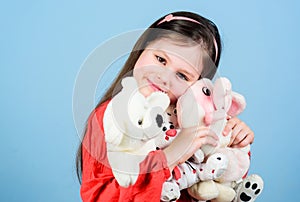 Childhood concept. Small girl smiling face with favorite toys. Happy childhood. Little girl play with soft toy teddy