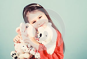 Childhood concept. Small girl smiling face with favorite toys. Happy childhood. Little girl play with soft toy teddy