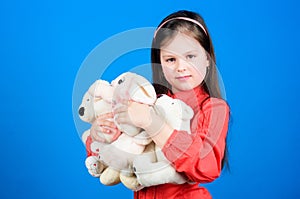 Childhood concept. Small girl smiling face with toys. Happy childhood. Little girl play with soft toy teddy bear. Lot of