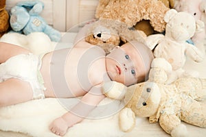 Childhood and curiosity concept. Baby boy with his soft toys