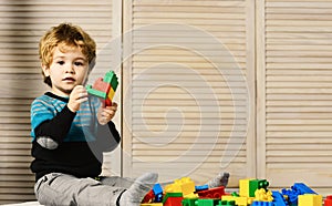 Childhood and educational activities concept. Boy plays with lego