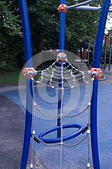 Childhood, equipment and object concept - climbing frame with slide on playground outdoors at summer