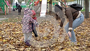 Childhood, family, infant, motherhood, autumn concept - slow motion 2 happy joyful little preschool minor kids with mom