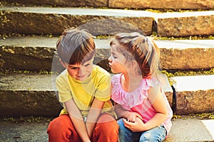 Childhood first love. summer holiday vacation. small girl and boy on stair. Relations. couple of little children. Boy