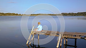 Childhood Fishing Adventures: Boy on the Pier, Hooking Fish on a Sunny Summer Day