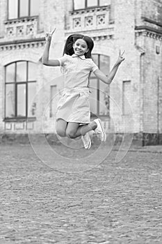 childhood happiness of cheerful teen girl jumping outside. photo of childhood happiness