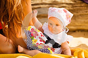 Little baby playing on beach during summertime