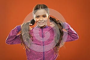 Childhood happiness. Family. Kid fashion and sportswear. Happy little girl with long hair. childrens day. Portrait of