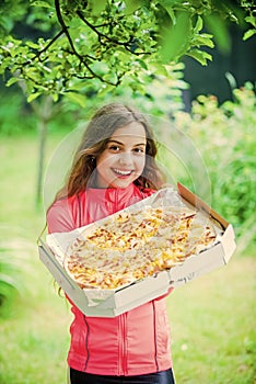 Childhood happiness. junk food concept. happy child hold big pizza. meal delivery. hungry kid eating pizza. looking