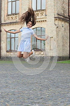 childhood happiness of teen girl jumping outside. image of childhood happiness of teen girl.