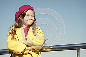Childhood is about happy memories. Smiling little kid in hat sky background. Small girl wear fall outfit outdoors