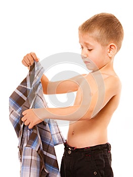 Childhood independence concept - little boy dressing up photo