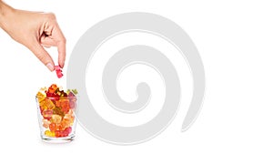 Childhood and jelly bears candies in hand isolated on white background. copy space, template