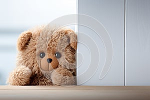 Childhood joy Cute teddy bear hides behind white wooden door
