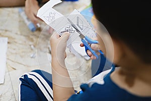 Childhood are learning to use scissors to cut paper.